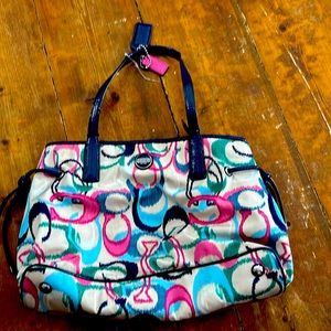 I’m selling a slightly used Coach Blue, Pink, Purple, White Turquoise Logo Purse